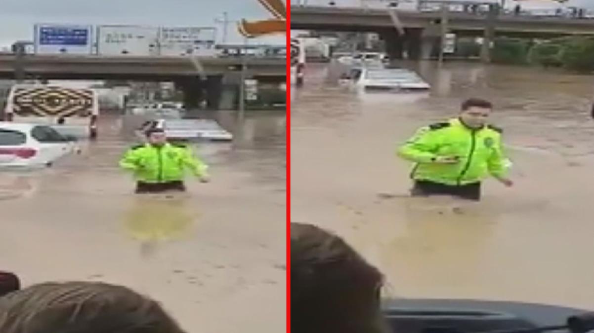 Beline kadar suya girip mahsur kalanları kurtarmaya çalışan komiserin görüntüleri büyük beğeni topladı