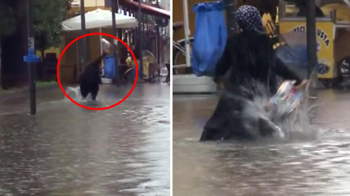 İzmir'i vuran selde dengesini kaybedip yere düşen kadın çaresizlikten suyu yumrukladı